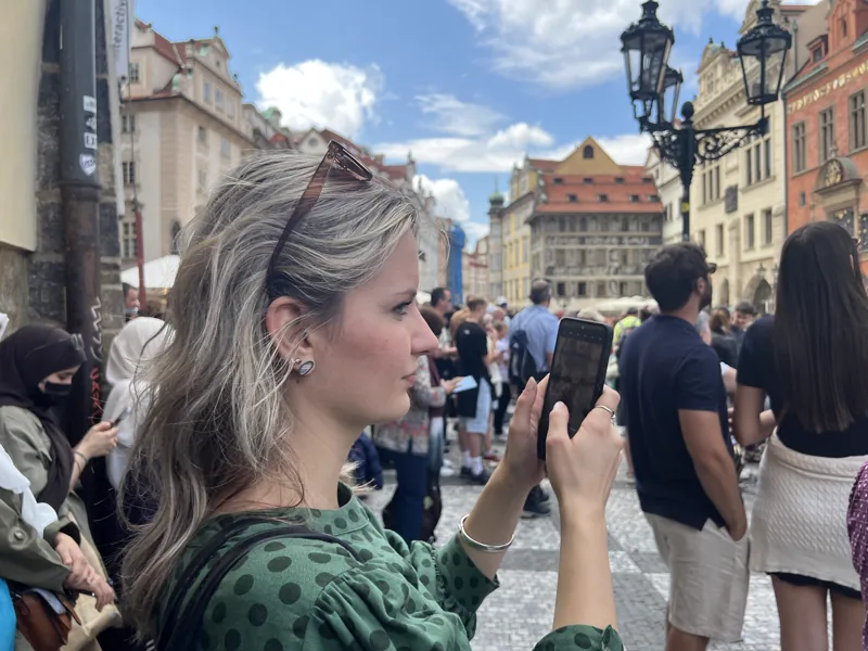 Journalism student photographing a story in central Prague