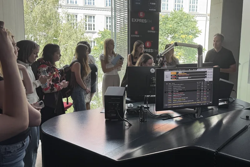 A student learning newsroom production in a professional studio