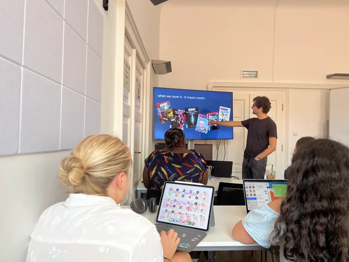 A journalism professional leading a student session